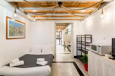 a bedroom with two beds and a tv in it at Sanniti Loft San Lorenzo in Rome