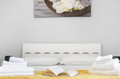 a bedroom with a bed with towels and a book at ArtStay AC Apt Near Metro, Fiumicino Airport in Rome