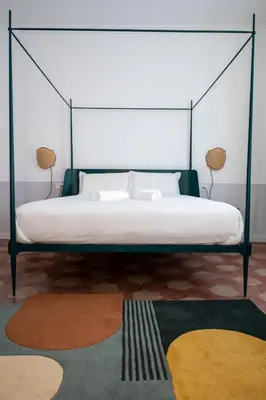 a bedroom with a canopy bed with two lamps at Dimora Malatesta @ The Vatican in Rome