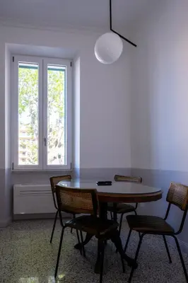 a dining room with a table and chairs and a window at Dimora Malatesta @ The Vatican in Rome