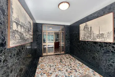 a room with black walls with pictures on the wall at Livorno by Halldis in Rome