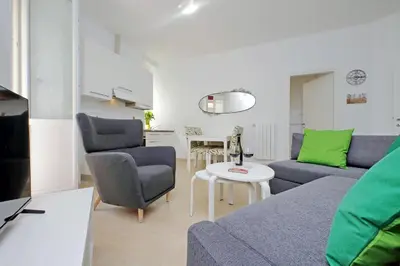 a living room with a couch and chairs and a table at Livorno by Halldis in Rome