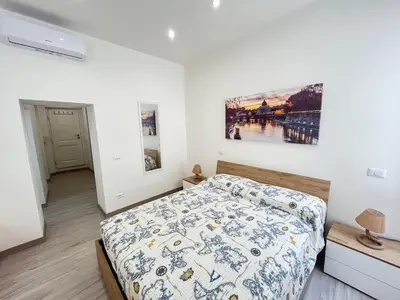 a bedroom with a bed and a painting on the wall at SpecchiamoR in Rome
