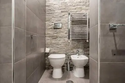 a bathroom with a toilet and a sink at Fori Imperiali Luxe Mansion in Rome
