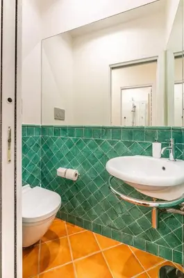 a bathroom with a sink and a toilet and a mirror at Fori Imperiali Luxe Mansion in Rome