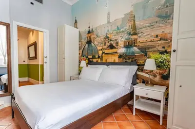 a bedroom with a bed with a painting on the wall at Fori Imperiali Luxe Mansion in Rome