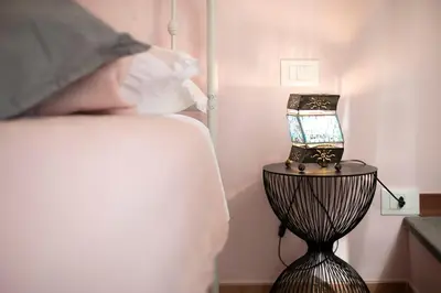 a person looking at a table with a lamp on it at Alchimia Friends and Family 3 bedrooms 3 bathrooms in Rome