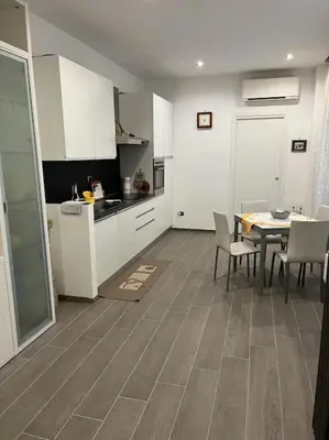 a kitchen and dining room with a table and chairs at Casa Dalia in Rome