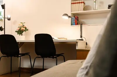 an office with two chairs and a desk with a computer at Central near Piazza Navona by NDP rent in Rome