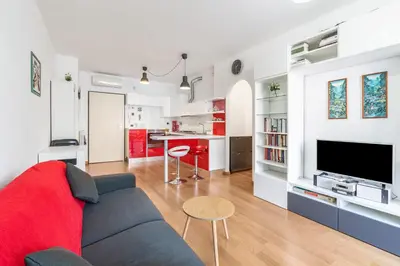 a living room and kitchen with a couch and a tv at Portuense 107 - Bright Flat in Rome