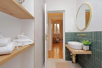 a bathroom with a sink and a mirror at YCH-Casa Bella- Luxury home near Piazza Venezia in Rome