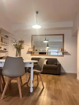 a living room with a table and chairs and a couch at Antinori Stresa Home in Rome