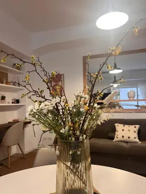 a vase with flowers on a table in a living room at Antinori Stresa Home in Rome