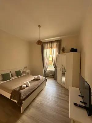 a bedroom with a bed and a large window at Colosseo House in Rome