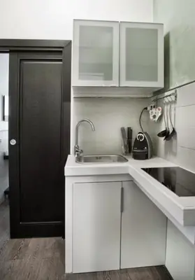 a kitchen with a sink and a black door at Parioli Suites Apartments in Rome