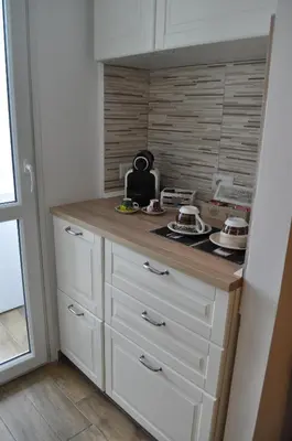 a kitchen with white cabinets and a counter top at A casa di Emi e Giò in Rome