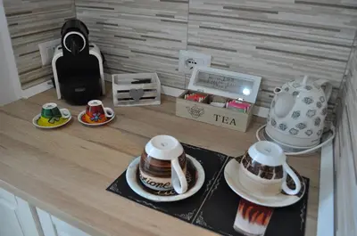 a counter with cups and saucers and a tea set at A casa di Emi e Giò in Rome