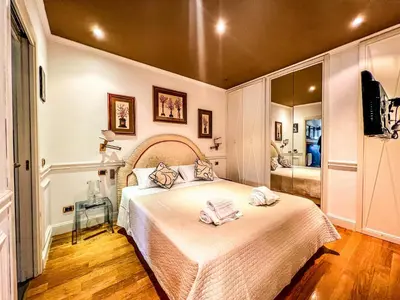 a bedroom with a bed with two towels on it at Qg Tacito 90 in Rome