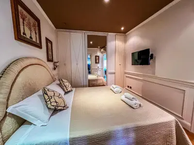 a bedroom with a bed with two towels on it at Qg Tacito 90 in Rome
