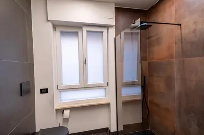 a bathroom with a window and a shower at Living Testaccio - Modern Apartment in Rome