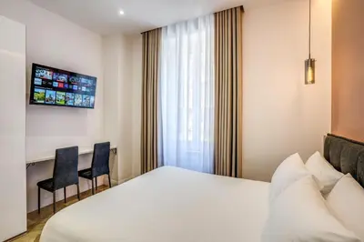a hotel room with a bed and two chairs at Vatican Eagle in Rome