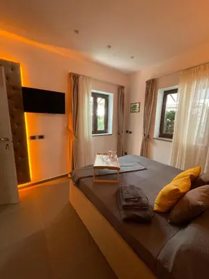 a bedroom with a large bed with a table on it at JOIVY Exclusive 2-Bedroom Villa with Private Garden - 5 minutes from the Colosseum in Rome