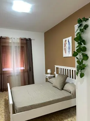 a bedroom with a white bed and a window at A & F Apartment in Rome