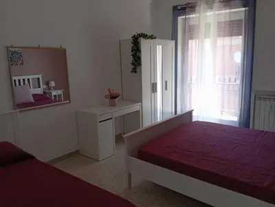 a bedroom with two beds and a mirror at A & F Apartment in Rome