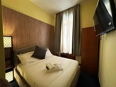 a hotel room with a bed with a phone on it at Hotel Rome place in Rome