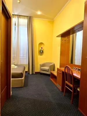 a hotel room with a bedroom with a bed and a desk at Hotel Rome place in Rome
