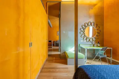a room with a bed and a table and a mirror at Elegant Diocleziano Suite in Rome
