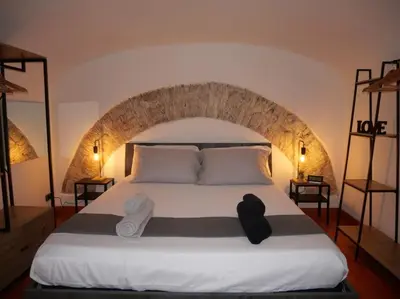 a bedroom with a bed with towels on it at Metro Roma Termini - Love in Loft in Rome