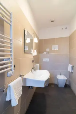 a bathroom with a sink and a toilet at Villa Borghese Prestige Rooms in Rome