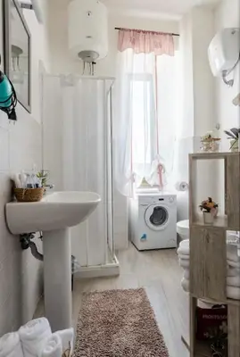 a bathroom with a sink and a washing machine at Fefe's House in Rome
