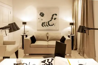 a living room with a couch and a chair at Viam Villa Futura in Rome