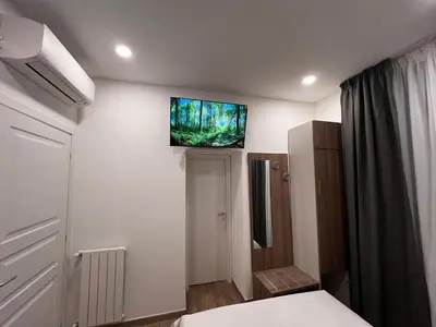 a room with a flat screen tv on the wall at Garden Of Vatican's in Rome