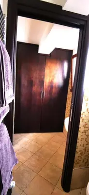 a door in a bathroom with a mirror at Penthouse loft with view in Rome
