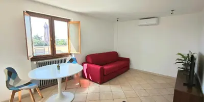 a living room with a red chair and a table at Penthouse loft with view in Rome