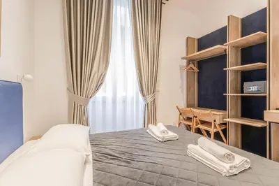 a bedroom with a bed with two towels on it at Coliseum sweet guest house in Rome