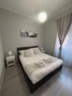 a bedroom with a bed with two towels on it at Le Quattro Stagioni Vatican City in Rome