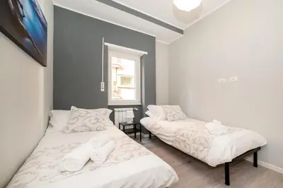 a bedroom with two beds and a window at Le Quattro Stagioni Vatican City in Rome
