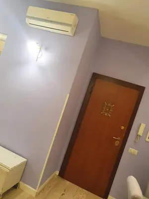 a room with a door and a air conditioner on the wall at Crismi house in Rome