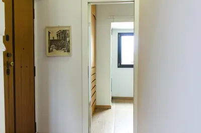a hallway with a mirror and a picture on the wall at Stylish Penthouse with terrace in Trastevere in Rome