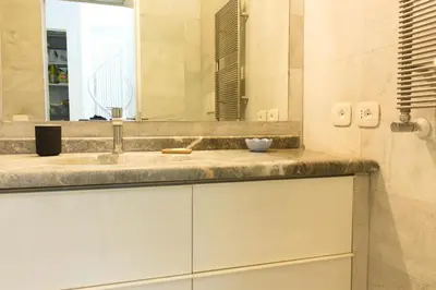 a bathroom with a sink and a mirror at Stylish Penthouse with terrace in Trastevere in Rome