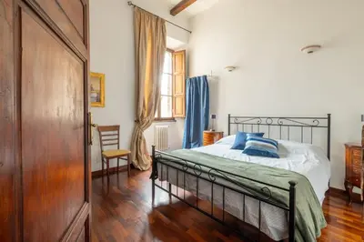 a bedroom with a bed and a wooden floor at Luxury apartment in the Heart of Rome - near metro A and B in Rome