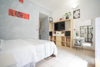 a bedroom with a bed and a tv and a table at Dimora San Giovanni in Rome