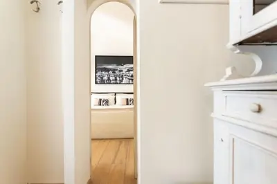a hallway with a mirror in a white room at MyRentalInn - Rome - Trastevere Arch Suite in Rome