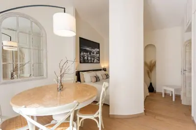 a living room with a table and a couch at MyRentalInn - Rome - Trastevere Arch Suite in Rome