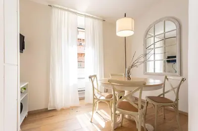a white dining room with a table and chairs at MyRentalInn - Rome - Trastevere Arch Suite in Rome
