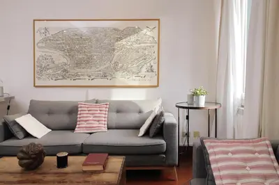 a living room with a gray couch and a table at Pantheon 2 Bedrooms in Rome